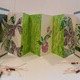 Tropical, Hand made accordion book<br>linocuts printed on rives BFK,collaged decorative papers raffia and beads